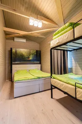 a bedroom with two bunk beds in a room at Bona Natura Nameliai in Bražuolė