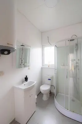 a bathroom with a toilet and a shower and a sink at Bona Natura Nameliai in Bražuolė