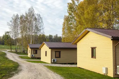 a row of rental houses on a dirt road at Bona Natura Nameliai in Bražuolė