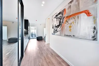 a hallway with a large painting on the wall at Jacuzzi Cinema Loft in Kaunas