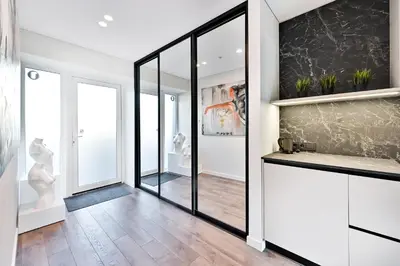 a room with a hallway with mirrors and a counter at Jacuzzi Cinema Loft in Kaunas