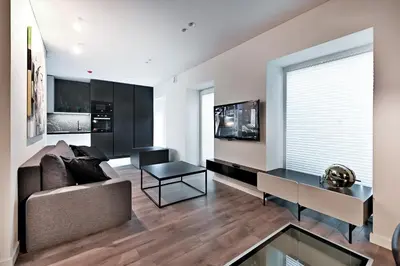 a living room with a couch and a table at Jacuzzi Cinema Loft in Kaunas