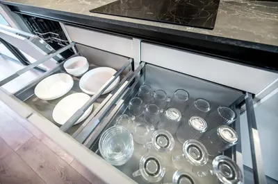 a dishwasher with dishes and glasses in it at Jacuzzi Cinema Loft in Kaunas