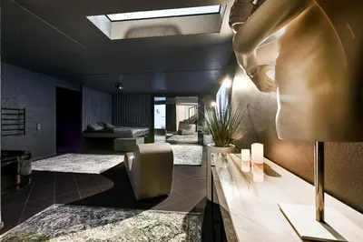 a lobby with a waiting area with a skylight at Jacuzzi Cinema Loft in Kaunas
