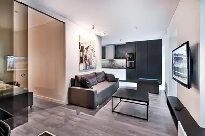 a living room with a couch and a table at Jacuzzi Cinema Loft in Kaunas