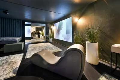 a living room with a couch and a flat screen tv at Jacuzzi Cinema Loft in Kaunas