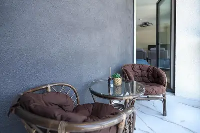 a glass table with two chairs and a glass table with a glass table at Kaunas City Center Deluxe in Kaunas