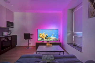 a living room with purple lighting and a tv at Kaunas City Center Deluxe in Kaunas