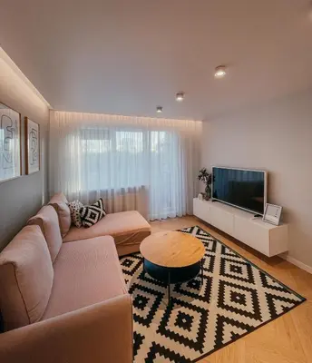 a living room with a couch and a flat screen tv at Vytautas Park Apartment with FREE Parking in Marijampolė