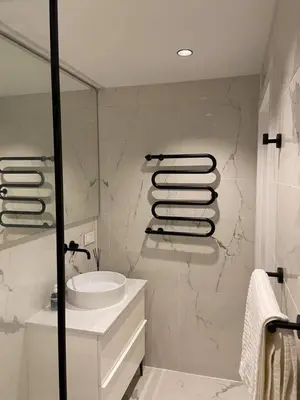 a bathroom with a sink and a shower at Vytautas Park Apartment with FREE Parking in Marijampolė
