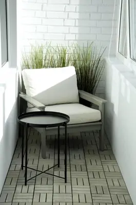 a white chair and a table in a room at Vytautas Park Apartment with FREE Parking in Marijampolė