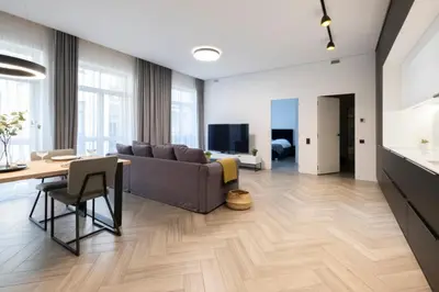 a living room with a couch and a table at cohost I OldTown 60m2 APT w-Garage Parking, Balcony & Self Check-in in Vilnius