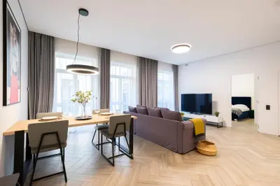a living room with a couch and a table at cohost I OldTown 60m2 APT w-Garage Parking, Balcony & Self Check-in in Vilnius