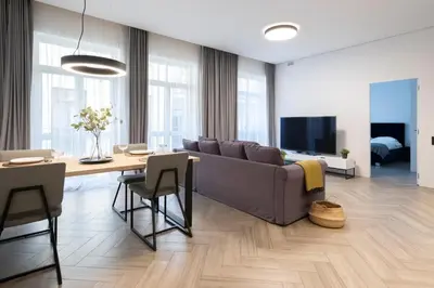 a living room with a couch and a table at cohost I OldTown 60m2 APT w-Garage Parking, Balcony & Self Check-in in Vilnius