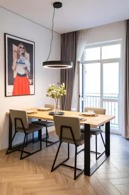 a dining room with a table and chairs at cohost I OldTown 60m2 APT w-Garage Parking, Balcony & Self Check-in in Vilnius