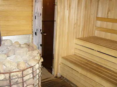 a room with a stack of logs next to a door at Likimo ratas in Paliepis