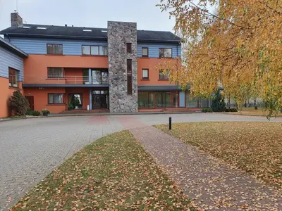 a building with a brick driveway in front of it at Vingis in Marijampolė