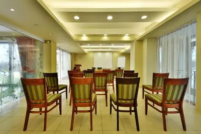 a waiting room with wooden chairs and a table at Vingis in Marijampolė