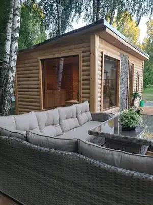 a large couch sitting in front of a small house at Žuvininkų pirtelė in Šiauliai