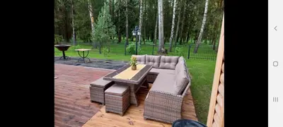a patio with a couch and a table in a park at Žuvininkų pirtelė in Šiauliai