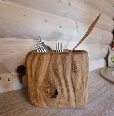 a wooden block with forks and knives in it at Žuvininkų pirtelė in Šiauliai