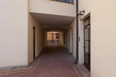 an empty hallway of a building with a gate at Uzupis Deluxe Retreat in Old Town Vilnius in Vilnius