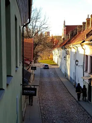 an empty alley with a car parked on a street at Uzupis Deluxe Retreat in Old Town Vilnius in Vilnius