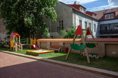 a yard with a playground with a play set at Uzupis Deluxe Retreat in Old Town Vilnius in Vilnius