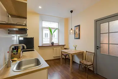 a kitchen with a sink and a table at Cozy studio and standard apartments in the heart of Oldtown in Vilnius