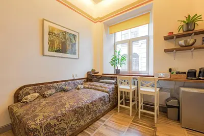 a living room with a couch and a bar at Cozy studio and standard apartments in the heart of Oldtown in Vilnius