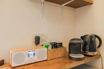 a counter with a microwave and a coffee maker on it at Cozy studio and standard apartments in the heart of Oldtown in Vilnius
