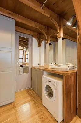 a laundry room with a washing machine in it at Cozy studio and standard apartments in the heart of Oldtown in Vilnius