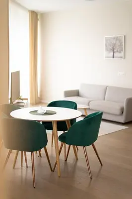 a living room with a table and four chairs at Apartment in Druskininkai City Centre in Druskininkai