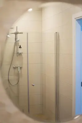 a shower with a glass door in a bathroom at Apartment in Druskininkai City Centre in Druskininkai
