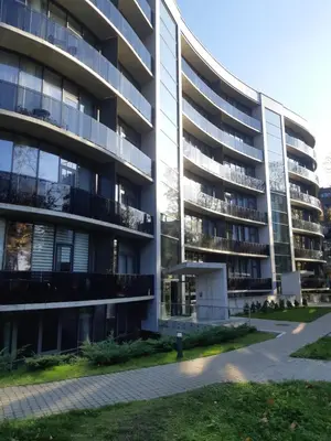 an apartment building with a sidewalk in front of it at Apartment in Druskininkai City Centre in Druskininkai