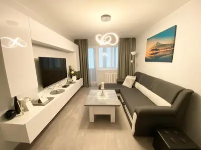a living room with a couch and a table at Studio flat in Panevezys in Panevėžys