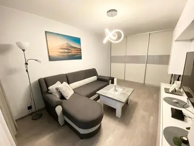 a living room with a couch and a table at Studio flat in Panevezys in Panevėžys