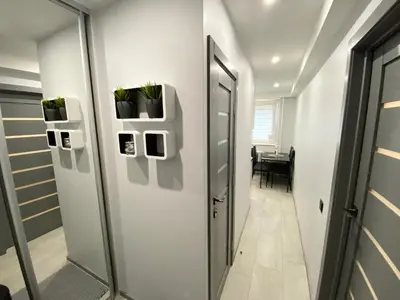 a hallway with a door with plants on it at Studio flat in Panevezys in Panevėžys