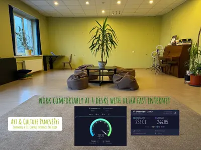 an empty room with a table and a potted plant at Art & Culture Panevėžys in Panevėžys