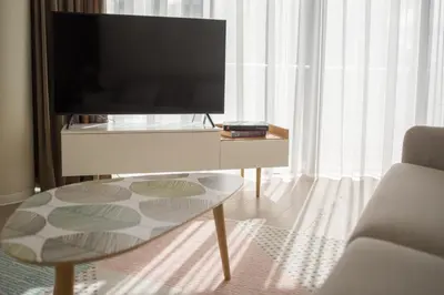 a living room with a tv and a coffee table at Apartment DoMiSol in Druskininkai