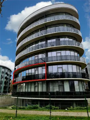 a round glass building with a red trim at Apartment DoMiSol in Druskininkai