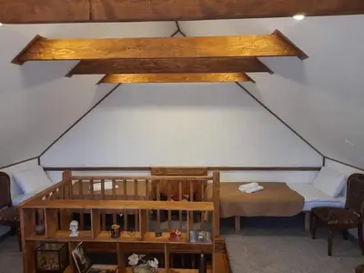 a room with a bed and a table and a ceiling at Molynė in Kaulakiai