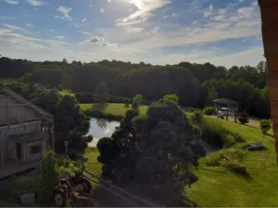 an aerial view of a house and a river at Molynė in Kaulakiai