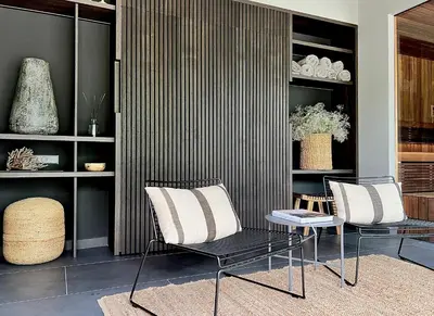 two chairs and a table in a room at The Lake - Waterfront Villas Retreat in Mindūnai