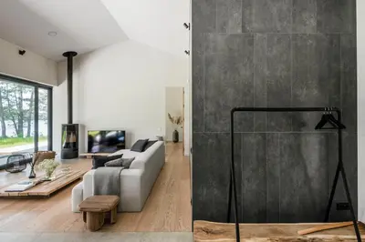 a living room with a couch and a table at The Lake - Waterfront Villas Retreat in Mindūnai