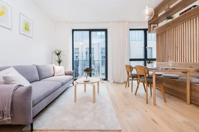 a living room with a couch and a table at cohost I NEW Apartment w-balcony, Self check-in at the Renesanso Complex in Vilnius