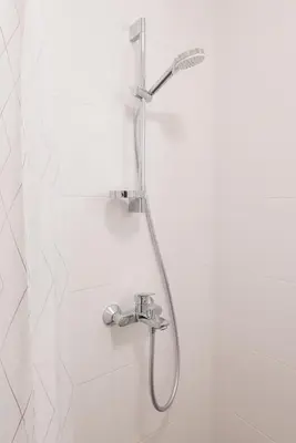 a shower with a shower head in a bathroom at cohost I NEW Apartment w-balcony, Self check-in at the Renesanso Complex in Vilnius