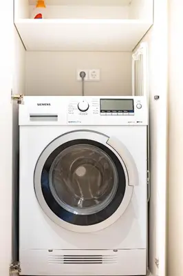 a white washer and dryer in a room at cohost I NEW Apartment w-balcony, Self check-in at the Renesanso Complex in Vilnius