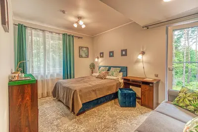 a bedroom with a bed and a couch at Vilhelmhaus in Dėdeliškės