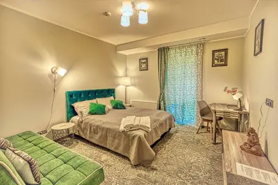 a bedroom with a bed and a couch and a desk at Vilhelmhaus in Dėdeliškės